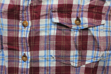 Flannel colorful shirt with front pocket and buttons. Casual plaid lumberjack shirt detail, purple & white color clothes close up top view