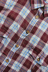 Fototapeta na wymiar Flannel colorful shirt fragment, cozy summer style plaid shirt. Vertical view of women clothing, tartan checkered fabric top view