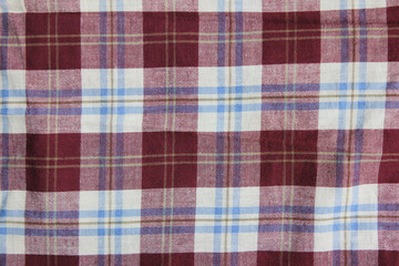 Tartan tablecloth fabric pattern, purple and white colour lumberjack style cloth texture. Plaid or flannel shirt material, buffalo style design fragment close up top view