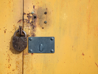 an old rusty padlock on an iron door