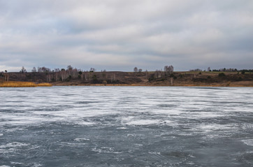 Fototapeta premium Frozen lake landscape in spring. Beautiful landscape of the lake in early spring in central Russia