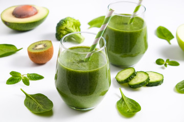 Freshly made green smoothie made of vegetables, fruits, herbs and greens. Glass of blended vegan...