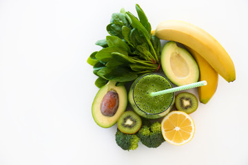 Freshly made green smoothie made of vegetables, fruits, herbs and greens. Glass of blended vegan...
