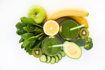 Freshly made green smoothie made of vegetables, fruits, herbs and greens. Glass of blended vegan...