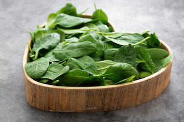 Fresh spinach leaves or spinach salad close up, background
