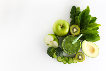 Freshly made green smoothie made of vegetables, fruits, herbs and greens. Glass of blended vegan...