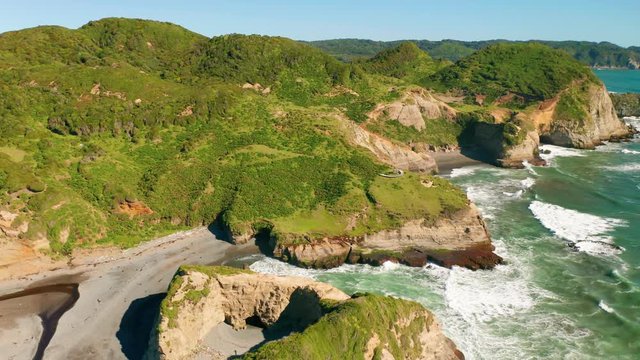 aerial view of the dock of time in the archipelago of chiloe with the waves of the pacific ocean hitting the rocks