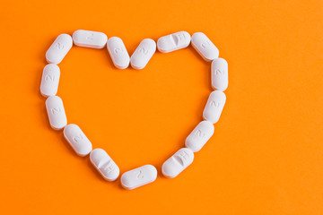 Heart with pills close up. Medical preparations are arranged in the shape of a heart. Pills close up. OGT pills heart. Analgesic pills close up. Antibiotics for viral and respiratory infections