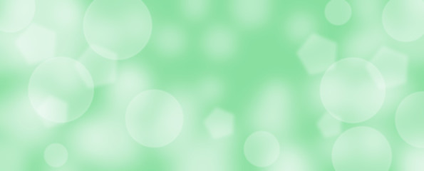 Abstract green bokeh banner background - birthday, father's day, valentine's day panorama - blurry bokeh circles on a green background. Christmas or spring concept