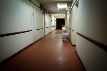 The gloomy corridor of the municipal budget hospital. Dark room, outdated architecture.