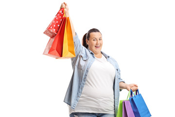 Happy overweight woman holding shopping bags