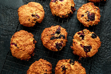 Home made Blueberry and walnut oat cookies on black background