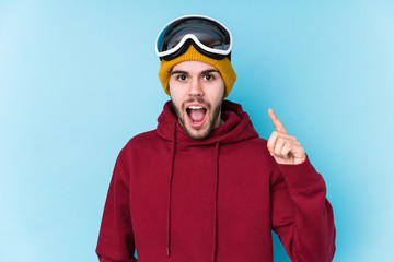 Young caucasian man wearing a ski clothes isolated having an idea, inspiration concept.