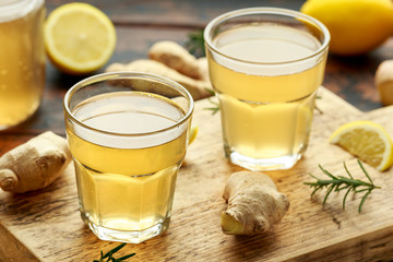 Kombucha Ginger, lemon Tea in glass ,on wooden board. healthy drink