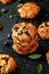 Home made Blueberry and walnut oat cookies on black background