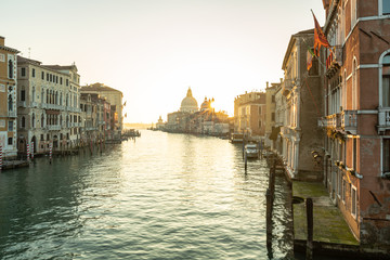 Naklejka premium canal in Venice, sunrise over the church