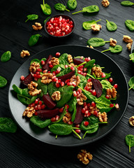 Healthy Beet Salad with fresh sweet baby spinach, pomegranate seeds and candy walnut. healthy Vegan vegetarian, plant based food