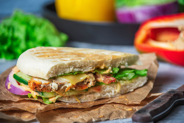 half of panini on parchment paper, rustic style