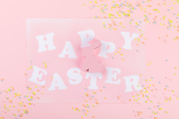 Happy Easter Greeting card with the inscription on a pink paper background.Concept of festive greetings