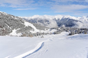 Winter scenery with ski slope and ski trace