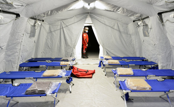 Empty hospital field tent for the first AID, a mobile medical unit of red cross for patient with Corona Virus. Camp room for people infected with an epidemic.