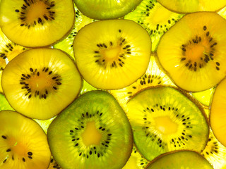 back lit abstract texture of yellow and green kiwi slices