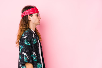Young hippie caucasian man isolated gazing left, sideways pose.