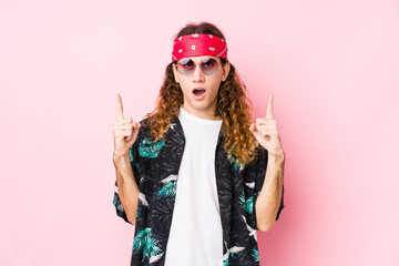 Young hippie caucasian man isolated pointing upside with opened mouth.