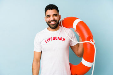 Young latin lifeguard man isolated happy, smiling and cheerful.