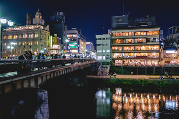 Fototapeta na wymiar Kyoto downtown, Kamo river and traditional restaurants at night