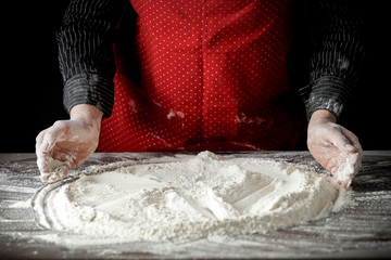 Flour on a kitchen table on a black moody background in the morning light