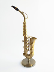 Close-up of elegant saxophone on white background. Side view of an extraordinary wind instrument...