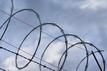 Barbed wire on blue sky background