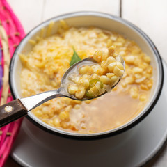 Mexican corn grain boiled also called esquites with cheese and mayonnaise on white background
