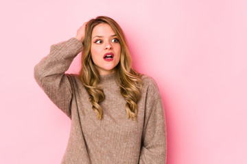 Fototapeta premium Young caucasian woman isolated on pink background being shocked, she has remembered important meeting.