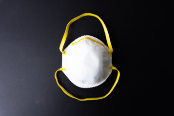 A white face mask on black background