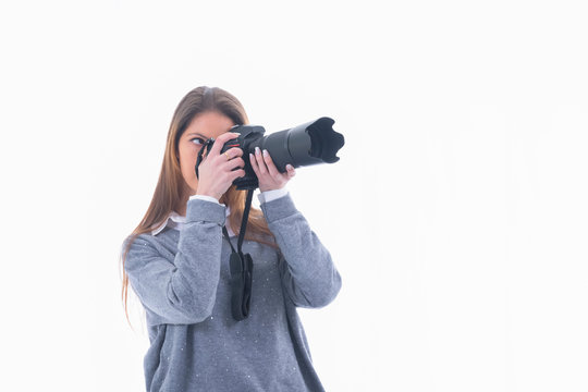 Focused Woman Looking Through A Camera Viewfinder