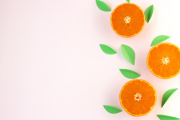 orange slices and green leaves on a white background. exotic background