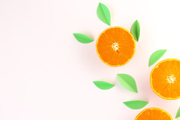 orange slices and green leaves on a white background. exotic background
