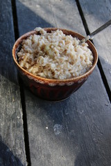 Plate of oatmeal porridge on a vintage table.