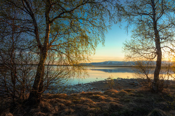 Morning sunrise on Lake Imandra. Against the backdrop of the Khibiny Mountains, Murmansk Region, Kola Peninsula.