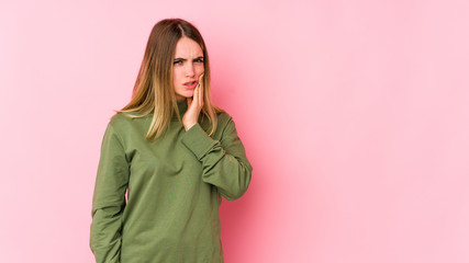 Fototapeta premium Young caucasian woman isolated on pink background having a strong teeth pain, molar ache.