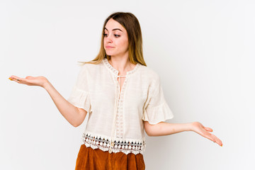 Young caucasian woman isolated on white background confused and doubtful shrugging shoulders to...