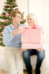 Obraz na płótnie Canvas Happy couple enjoying Christmas atmosphere