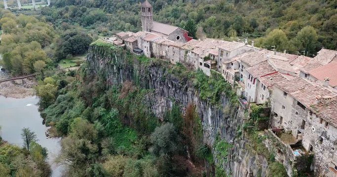 Aerial view of Castellfollit de la Roca, medieval Catalan hamlet on cliff on autumn day
