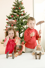 Happy children playing with puppets and enjoying Christmas atmosphere