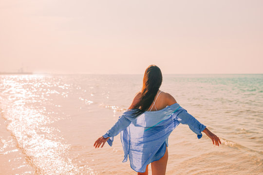 Woman Laying On The Beach Enjoying Summer Holidays Looking At The Sea