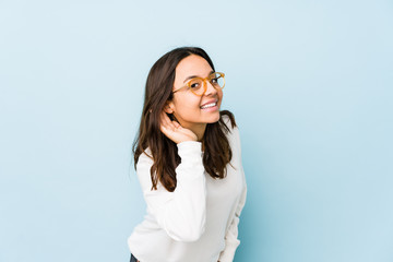 Young mixed race hispanic woman isolated trying to listening a gossip.