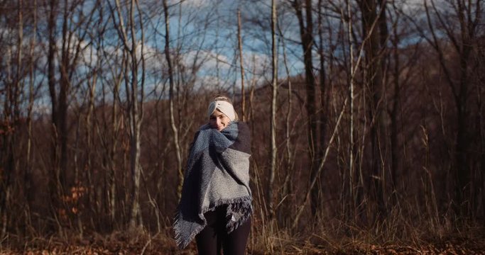 hapy woman smiling into camera in autumn