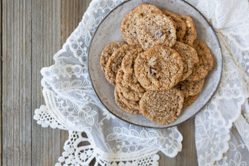 Oatmeal cookies on plate with lace and wood
